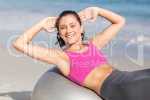 Fit woman stretching on exercise ball