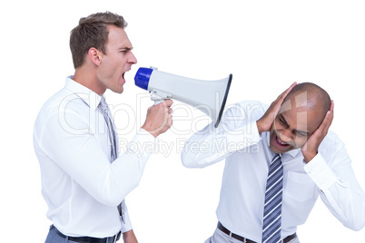 Businessman yelling with a megaphone at his colleague