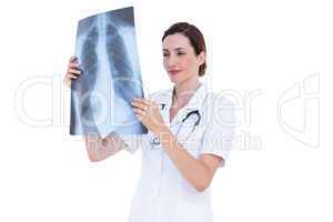 Confident doctor looking at x-ray