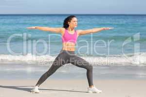 Fit woman doing fitness beside the sea