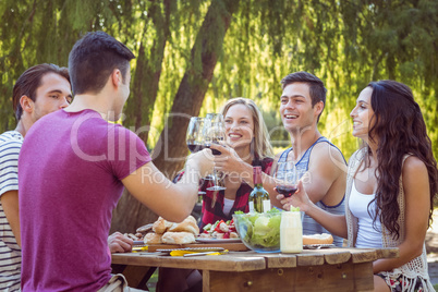 Happy friends in the park having beers