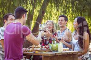 Happy friends in the park having beers