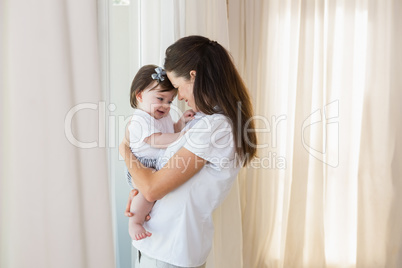 Happy mother with her cute baby girl