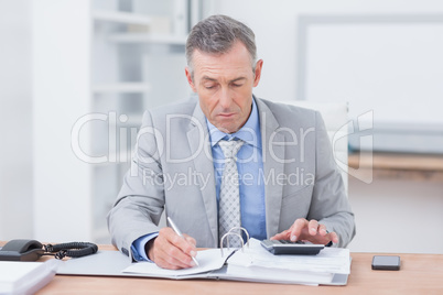 Concentrated businessman working in his desk