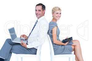 Businesswoman using laptop and tablet