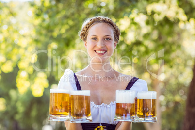 Pretty oktoberfest blonde holding beers