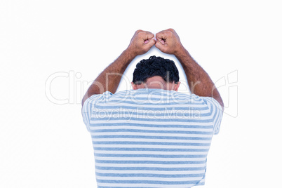 Rear view of sad man leaning his head against a wall