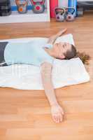 Woman relaxing on exercise mat