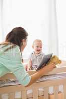 Happy mother using tablet with his baby boy