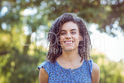 Pretty curly hair girl in a park