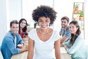 Young creative businesswoman smiling at the camera