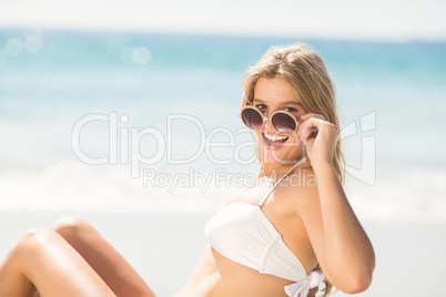 Happy pretty blonde looking at camera with sunglasses