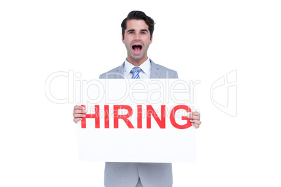 Happy businessman holding a hiring sign