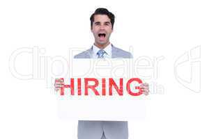 Happy businessman holding a hiring sign