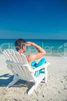 Man relaxing on deck chair at the beach