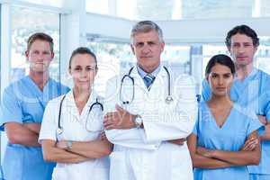 Team of doctors standing arms crossed