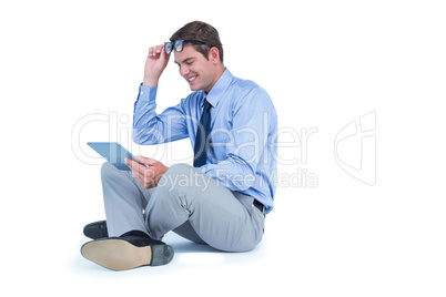 Businessman sitting and using tablet