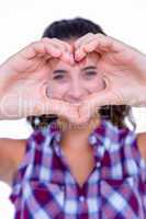 Happy pretty woman making heart shape with hands