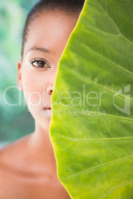 Pretty woman looking through leaves