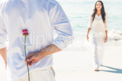 a man is offering a rose to his girlfriend
