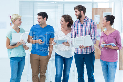 Creative colleagues with laptop and digital tablet office