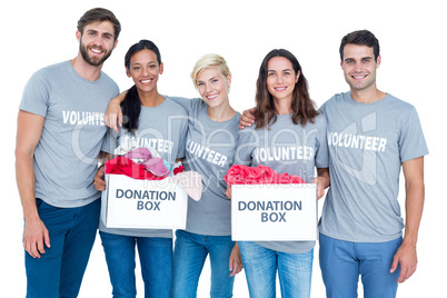 Happy volunteers friends holding donation boxes