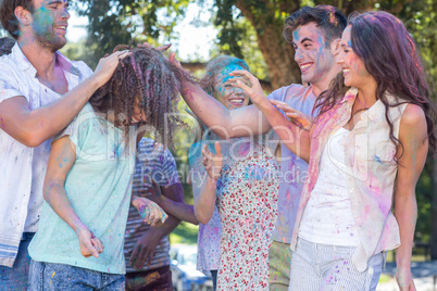 Friends throwing powder paint