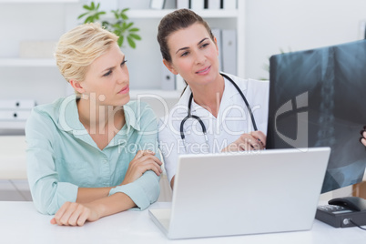 Doctor showing X rays to her patient