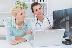 Doctor showing X rays to her patient