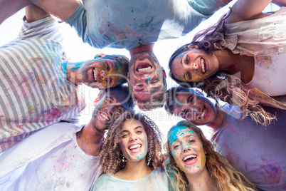 Happy friends covered in powder paint