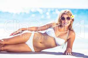 Pretty blonde woman lying beside the sea