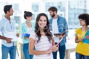 Casual woman with her colleague behind in the office