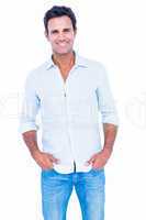 Happy handsome man looking at camera with hands in pocket