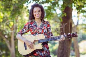 Happy friend playing guitar