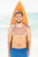 Handsome man holding surfboard