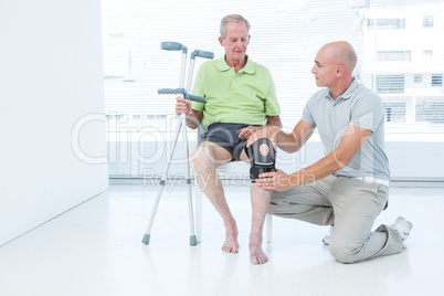 Doctor examining his patient knee