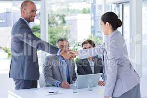 Interview panel shaking hands with applicant