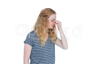 Woman with headache pinching her nose