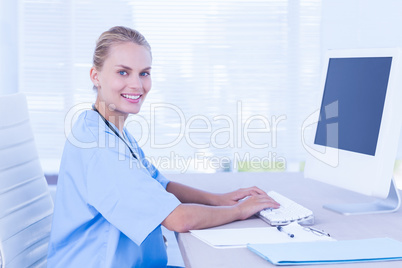 Happy doctor using computer