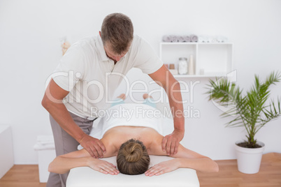 Physiotherapist doing arm massage to his patient