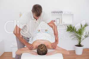 Physiotherapist doing arm massage to his patient