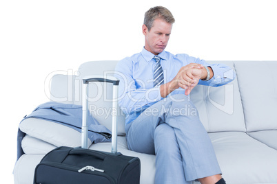 Elegant businessman with laptop sitting on sofa at home