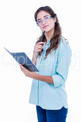 Thoughtful geeky hipster with a pen against her chin checking he