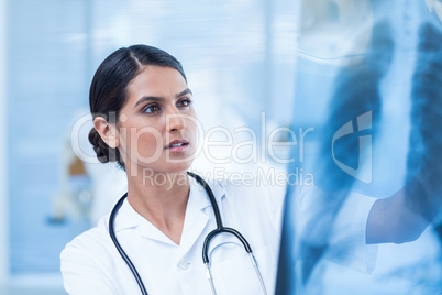 Beautiful doctor analyzing xray