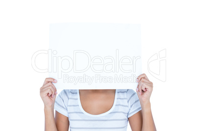 Woman putting paper over her faces