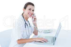 Doctor working on her laptop and calling