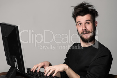 Funny and crazy man using a computer