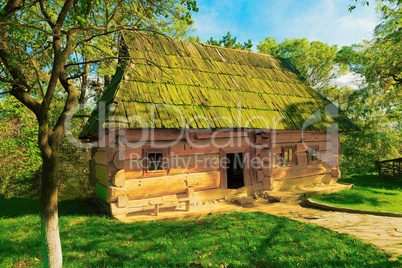 Old  log cabin with a bench at the entrance