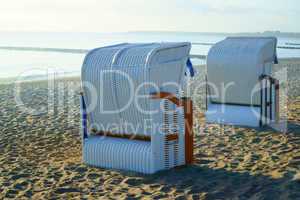 Two roofed wicker beach chairs at the baltic sea