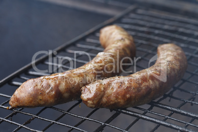 beautiful delicious sausages on charcoal